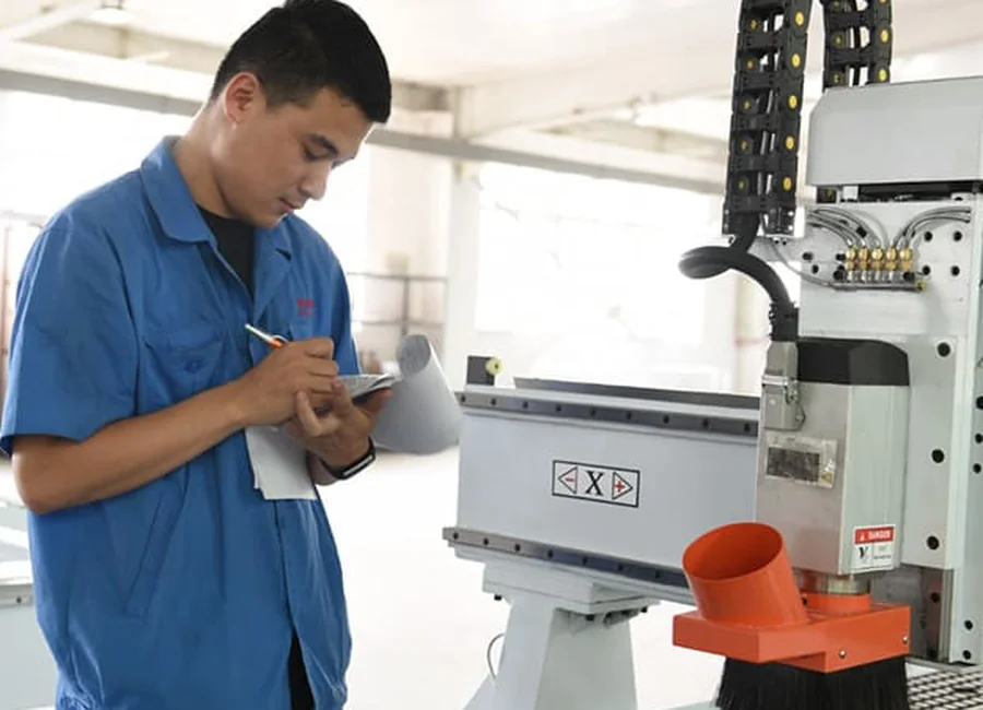 Técnico da Quick CNC verificando as ferramentas próximo ao spindle de um Router CNC
